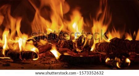 Burning firewood in a pizza oven close up