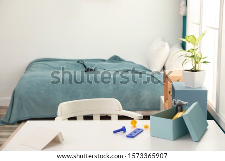 Modern child room interior with desk and comfortable bed