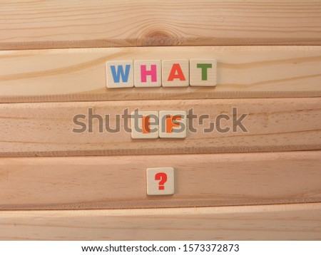 Word What if with question mark on wood background
