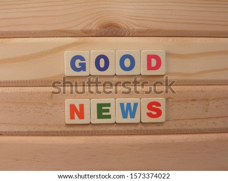 Word Good News on wood background