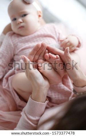 baby's tiny feet in paren't hands. parent holding newborn in arms. happy family