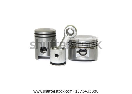 Small engine pistons on a white background, automotive


