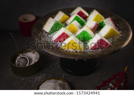 colored pieces of marshmallows on a vintage tray sprinkled with coconut and powdered sugar