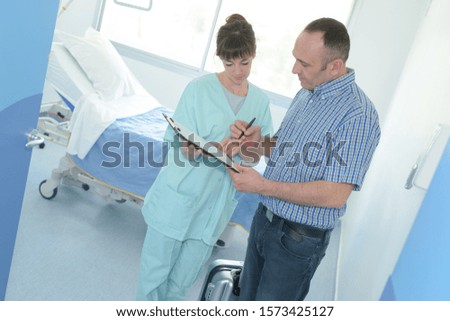 patient signing medical health record paper form