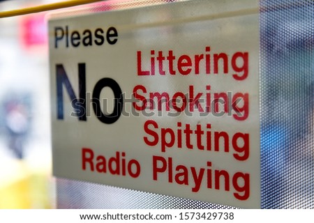 Please. No littering, smoking,sitting, radio playing. Inscription on a showcase.