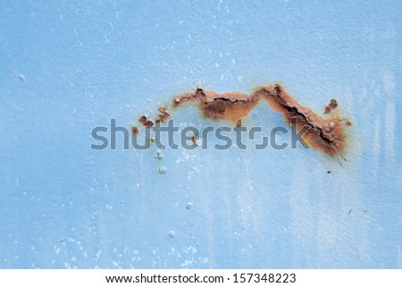 Rust on a Light blue metal sheet wall background, close up