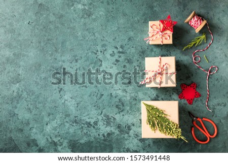 Preparing for Christmas holidays.Wrapping Gift Box with with ribbon and festive decor elements. Traditional Decorations. Background.  Xmas and Happy New Year card. Flat lay, top view