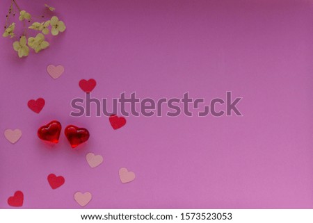 Red and pink hearts on the purple background. Valentin's Day, top view. Copy space. Flat lay