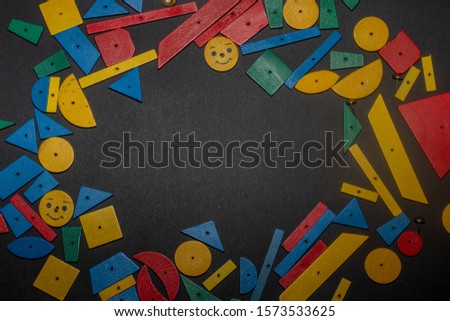 Colorful wooden bricks on gray background. studying of time by the child. Place for text, Early learning. Developing toys and motor skills. board game