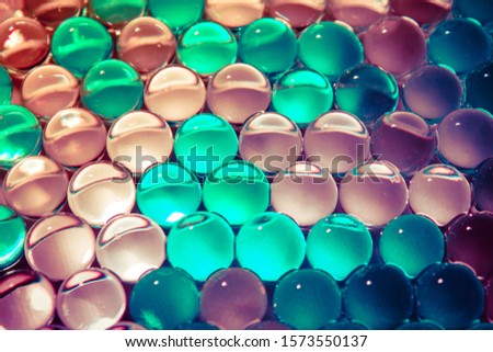 Macro of colorful hydrogel. Bright round gel balls cold color. Abstract christmas winter background