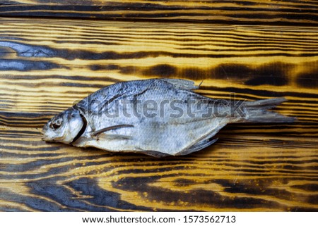 salted dry fish on a wooden background, top view