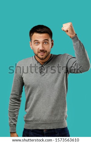 portrait of angry bearded man isolated on blue background.