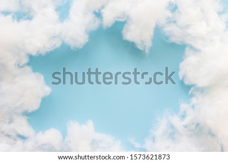 Soft clean cotton on light blue background.Frame clouds and copy space Royalty-Free Stock Photo #1573621873