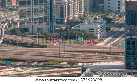 Aerial view of highway interchange in Dubai downtown timelapse. Cityscapes traffic bridge and parking. Roads and lanes Crossroads, Dubai, United Arab Emirates
