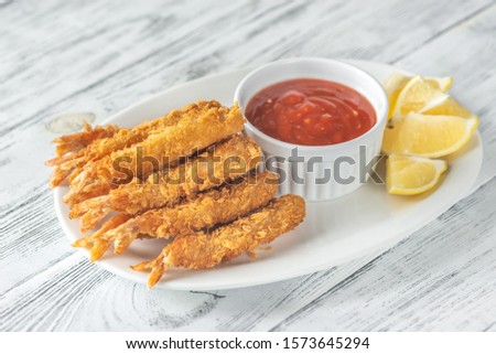Shrimp tempura with sauce and lemon wedges on the plate Royalty-Free Stock Photo #1573645294