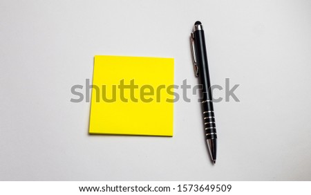 sticky reminder reminder with black handle on light background - set of notepad stacks with different color options, office communication concept