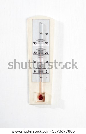 Vintage thermometer for measuring temperature on a wooden white table Royalty-Free Stock Photo #1573677805