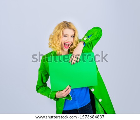Winking woman holds advertising board. Market, shop, sale, discount. Advertising and sale. Advertising banner. Seasons sale. Discount. Copy space for text. Stylish woman holds sign board. Sign board.