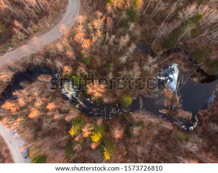 Waterfall and country dirt road in the wild forest of Karelia