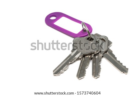 House key with tag label isolated on white background 