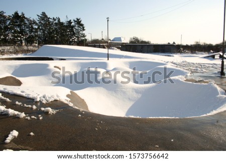 Snowy skatepark during the day
