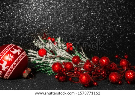 2020 New year composition. Stylish decor concept, red christmas bauble, fir branch with holly berries on black bokeh sparkling backdrop. Flat lay, copy space. For postcard, for desktop.