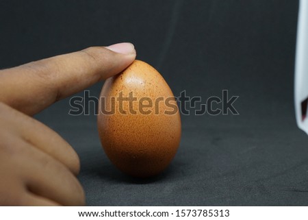 Chicken eggs on the hand, gray background