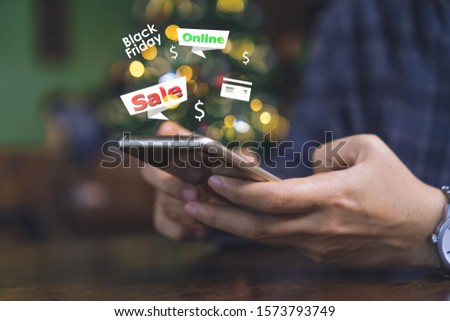 Women hand using smartphone do online selling for people or shopping online with chat box, cart, dollar icons pop up. Social media maketing black friday big sale of the year concept.