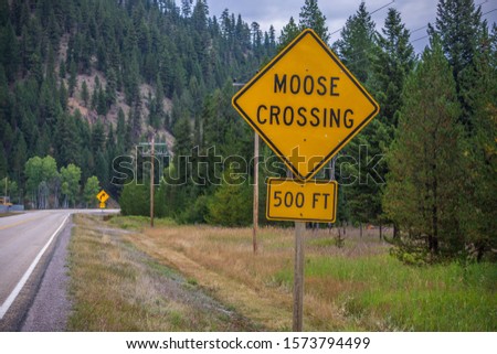 Moose Crossing Yellow Road Highway Sign In Montana National Forest Scenic Drive