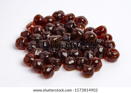 A picture of pearl tea or some call tapioca pearl used for boba tea on white background. Royalty-Free Stock Photo #1573814902