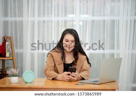 Young beautiful pregnant woman working on laptop. Pregnant business woman searching information and online shopping on laptop prepare for childbirth and parenting on sofa at home