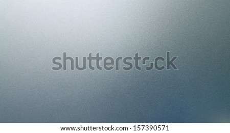 Abstract texture of grey and light blue smooth brushed metal background