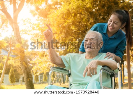 Happy family lifestyle concept. Asian woman take care his father 80 year who has alzheimer's disease. Senior man very happy when go to park. Concept freelance nurse with old people or Father's Day.