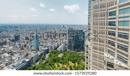 Aerial skyline of Shinjuku skyscrapers and buildings on a sunny day, Tokyo.