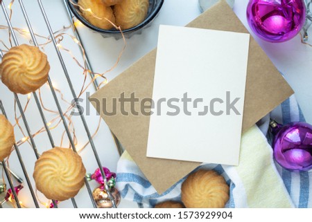 card mockup with garland. handmade cookies. new year decoraton with Christmas invitation 