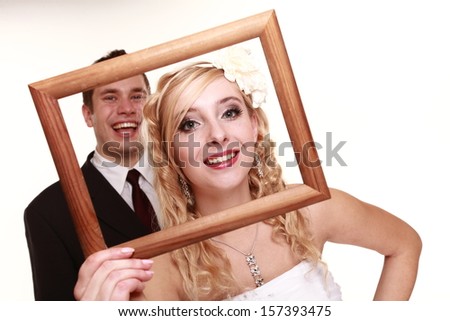 Wedding couple in the frame. Portrait of happy bride and groom. Isolated on white