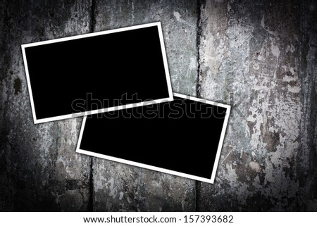 Vintage blank photo frames on a wooden background