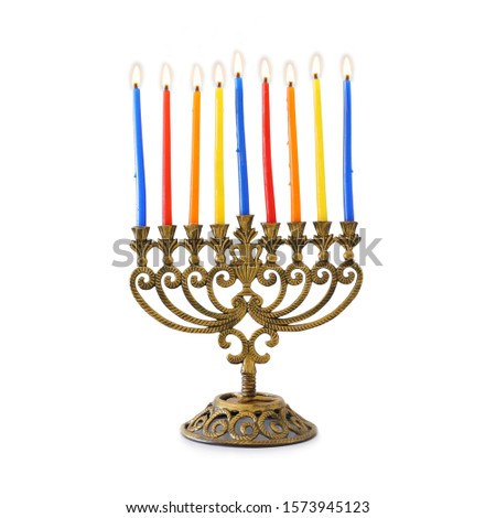 religion image of jewish holiday Hanukkah with brass menorah (traditional candelabra) and colorful candles isolated over white background