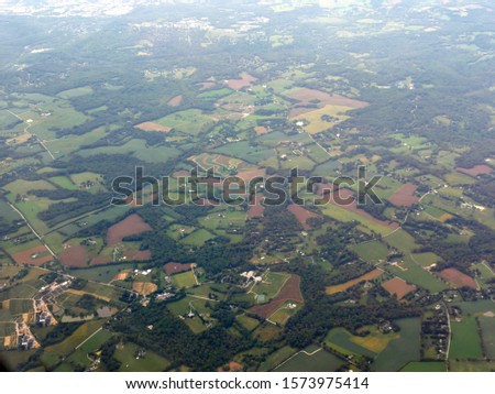 Lush farmlands approaching Maryland, seen from an airplane window