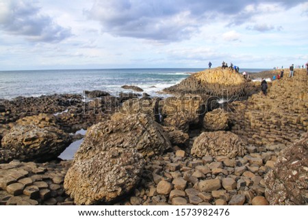 Giant's Causeway, Northern Ireland - October, 2019: Amazing nature and landscapes in UK, interlocking basalt columns resulting of an ancient volcanic fissure eruption.