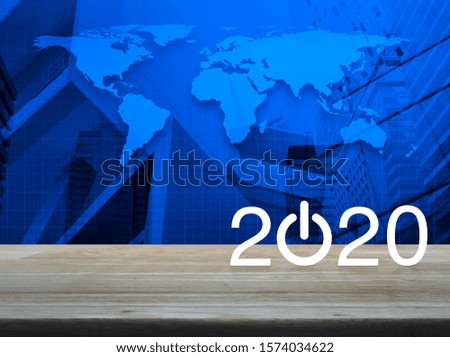 2020 start up business flat icon on wooden table over world map and modern office city tower and skyscraper, Happy new year 2020 concept, Elements of this image furnished by NASA