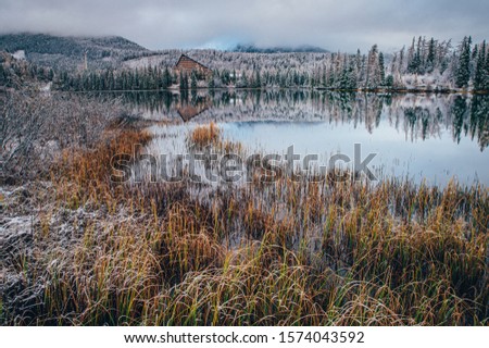 Lake in mountains between autumn and winter, original wallpaper