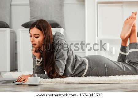 Woman in home interior and free space for your decoration.White wall background with fireplace.Copy space and wooden floor.