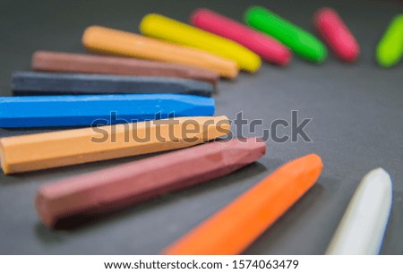 closeup focused crayons in circle on a black background