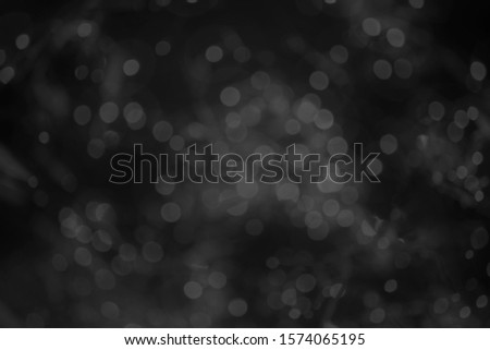 Abstract background white bokeh dispersion on a black background  