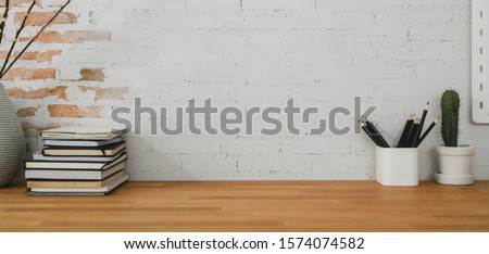 Cropped shot of comfortable office room with office supplies and copy space on wooden table 