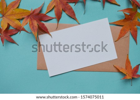 card mockup .envelope mockup ,and red maple leaves on blue and green background