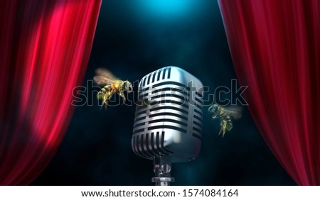 Flying bees with microphone. Buzzing noise concept. Royalty-Free Stock Photo #1574084164
