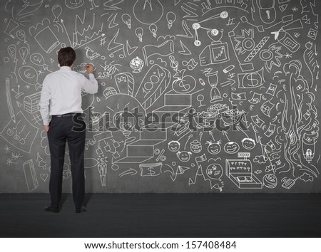 businessman drawing on the wall by chalk