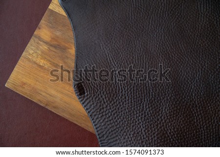 Texture brown leather on leather craftman's work desk. Leather Craft or leather working